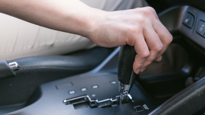 driver's hand on shift lever