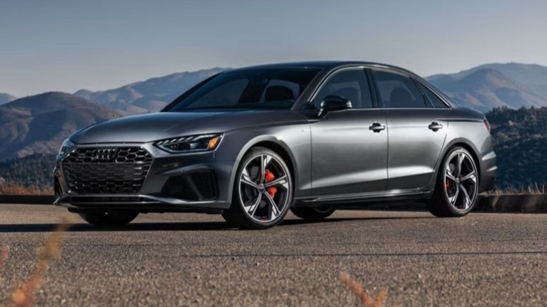 2025 Audi A4 parked on a paved surface with mountains in the background