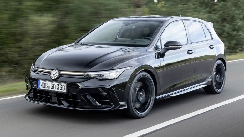 Golf R Black Edition driving down a road with trees in the background