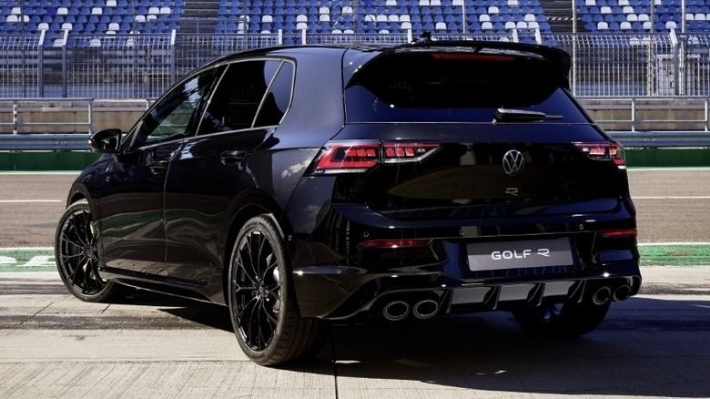 Rear shot of a parked Golf R Black Edition with grandstands in the background