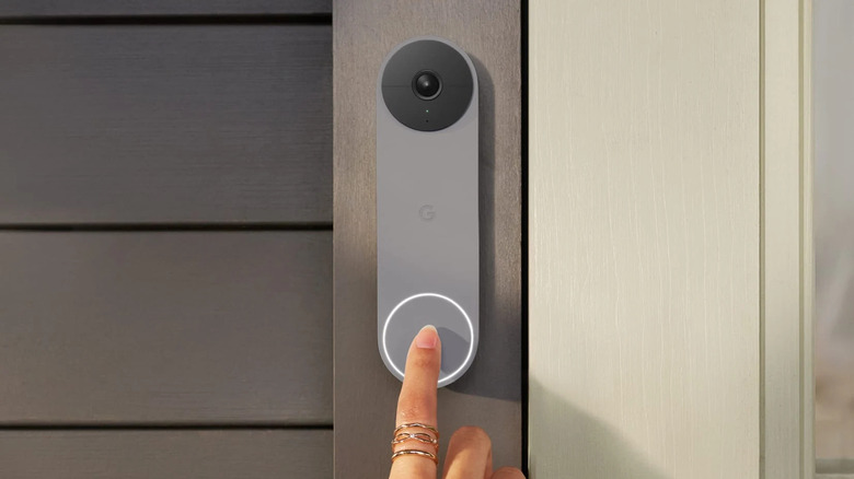 Finger pressing Nest Doorbell