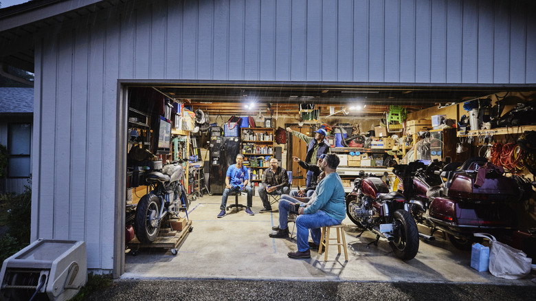 Friends relaxing in garage