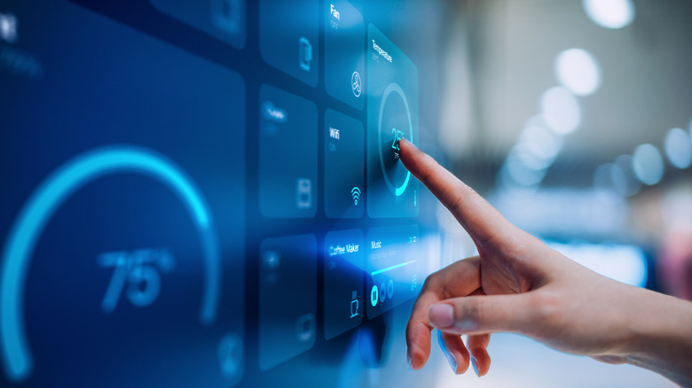 Close up of woman's hand setting up smart home system