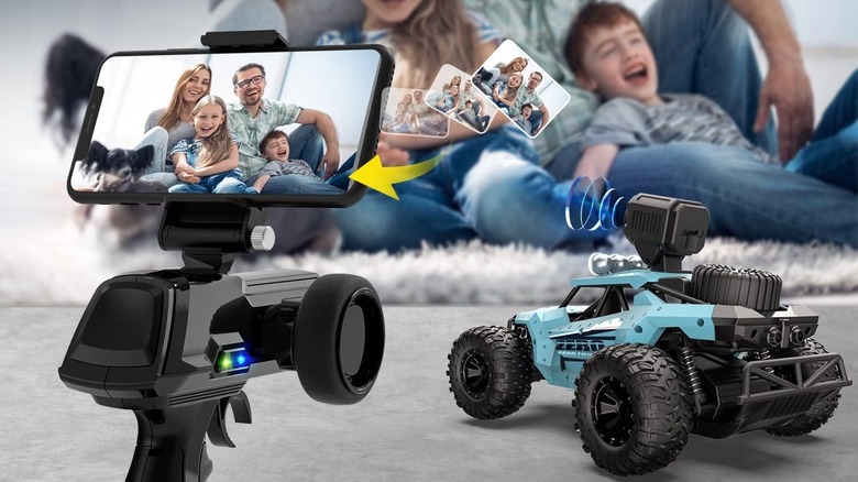 Family laughing in front of toy car with camera