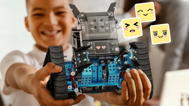 Child holding a Makeblock mBot2 Rover