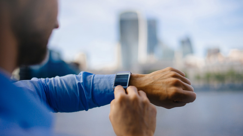 Man looking at smartwatch