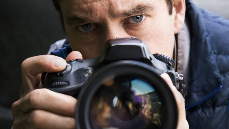 man taking picture with camera