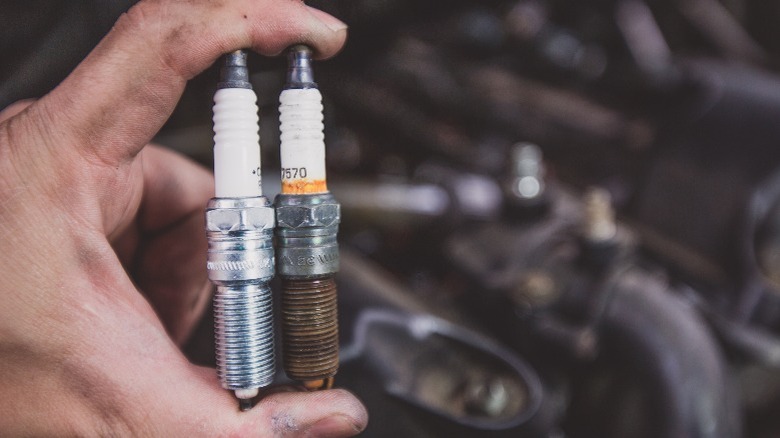 new and old spark plugs