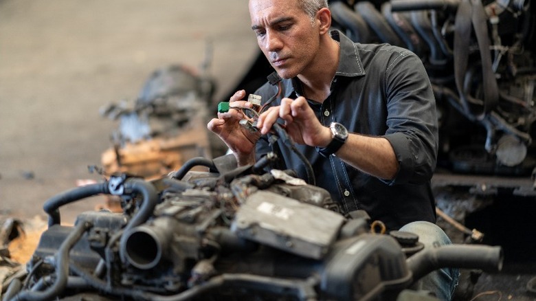 person inspecting an engine