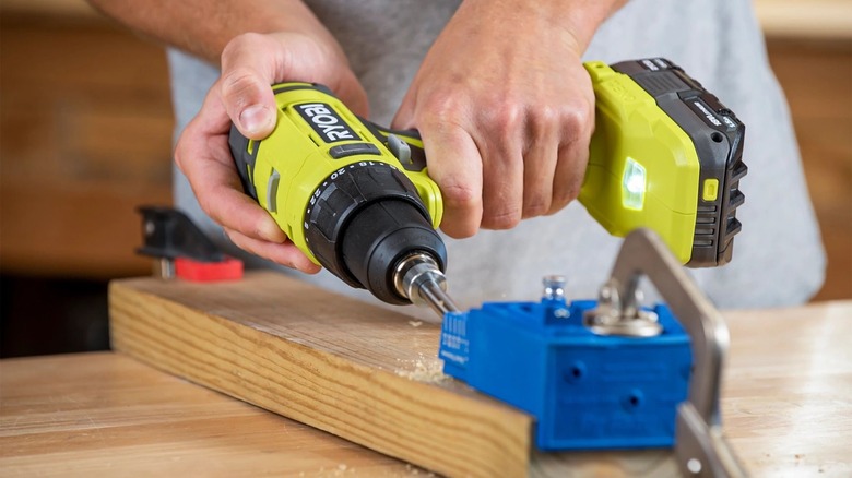 Person using a Ryobi drill