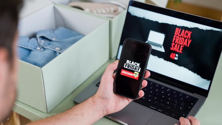 person looking at screen with Black Friday Sale