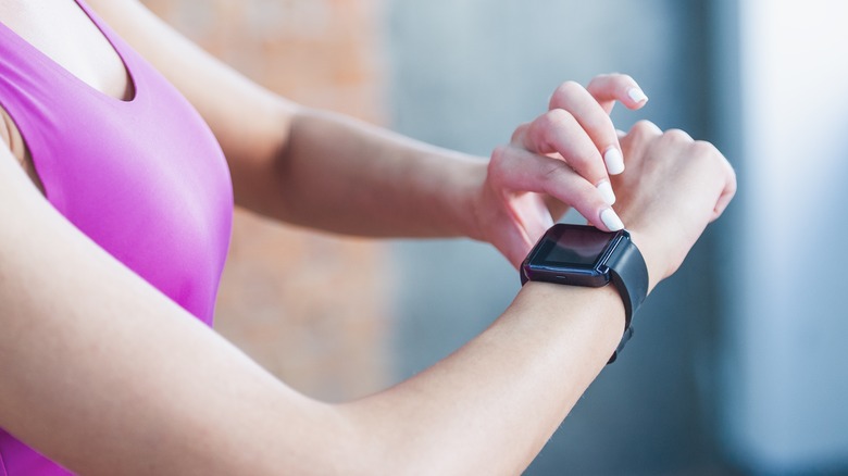 Woman adjusting her Fitbit