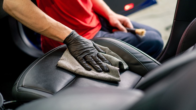 person detailing car interior