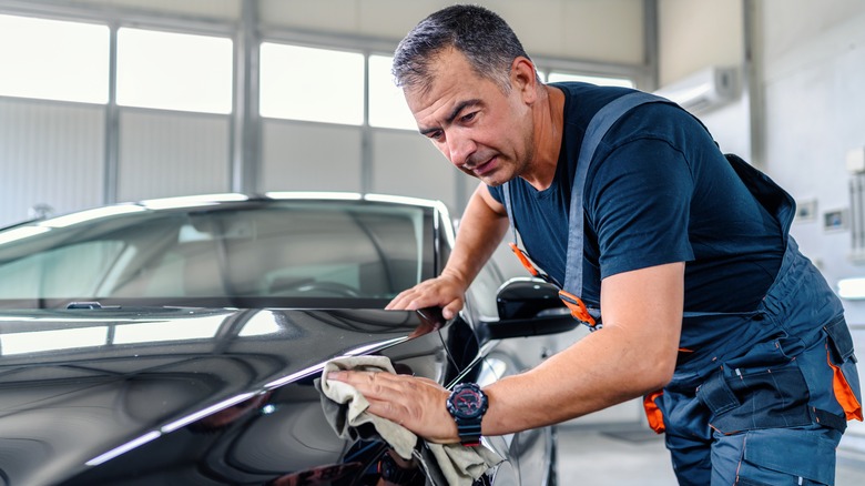 man cleaning car