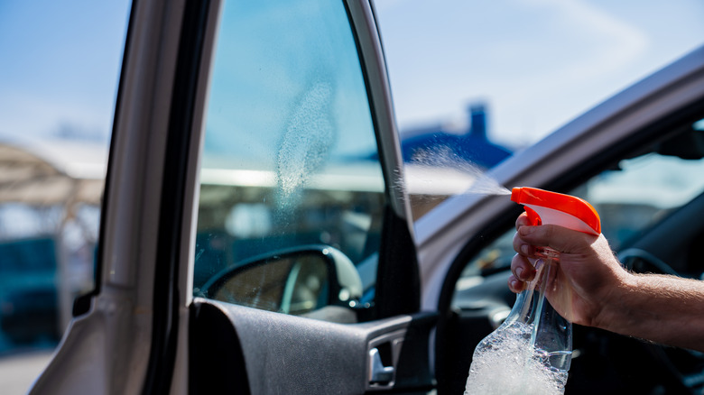 person cleaning car window