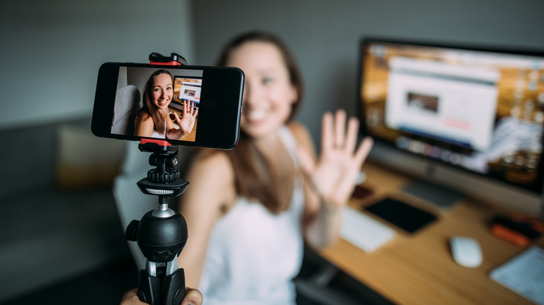 woman using iPhone to film herself