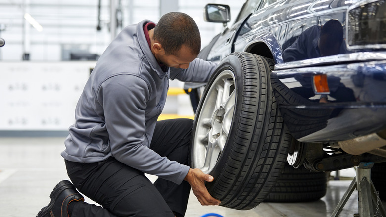 Man replacing his back car tire