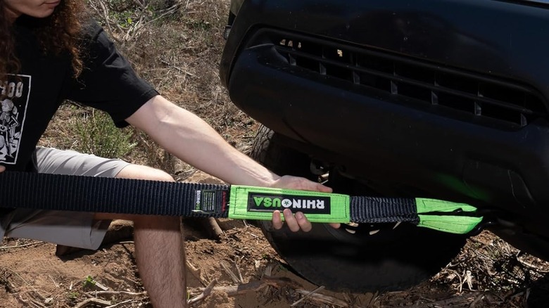 man holding the Rhino recovery tow strap