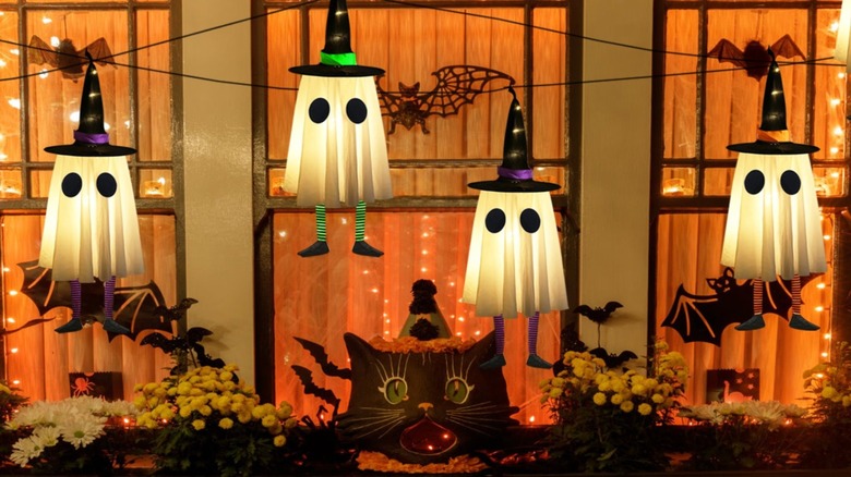 Four ghost decorations in front of a window