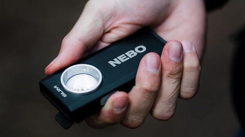 Small NEBO flashlight in a person's hand