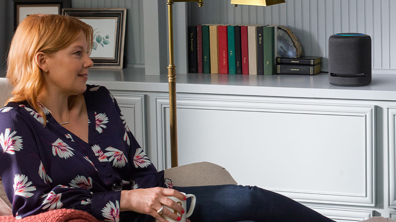 woman listening to Amazon Echo Studio speaker