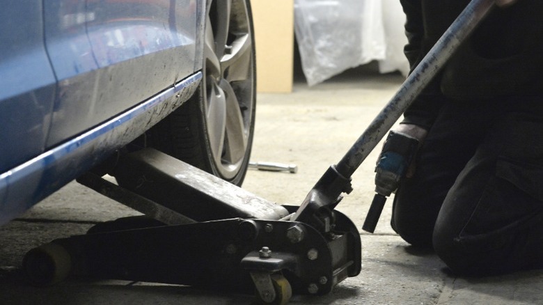 person using a floor jack