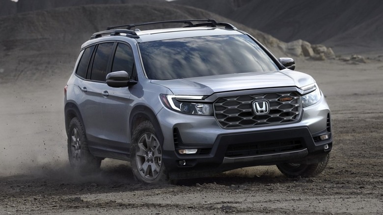 silver 2024 Honda Passport TrailSport kicking up dust