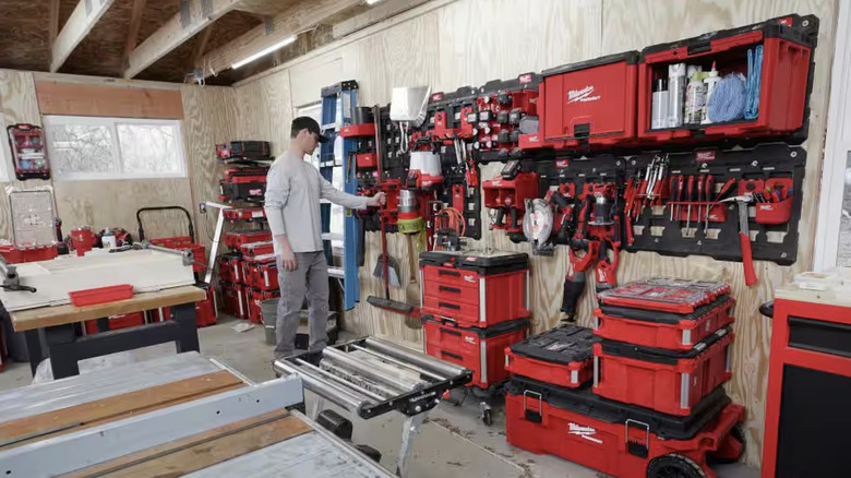 A man with his Milwaukee Packout collection in a garage