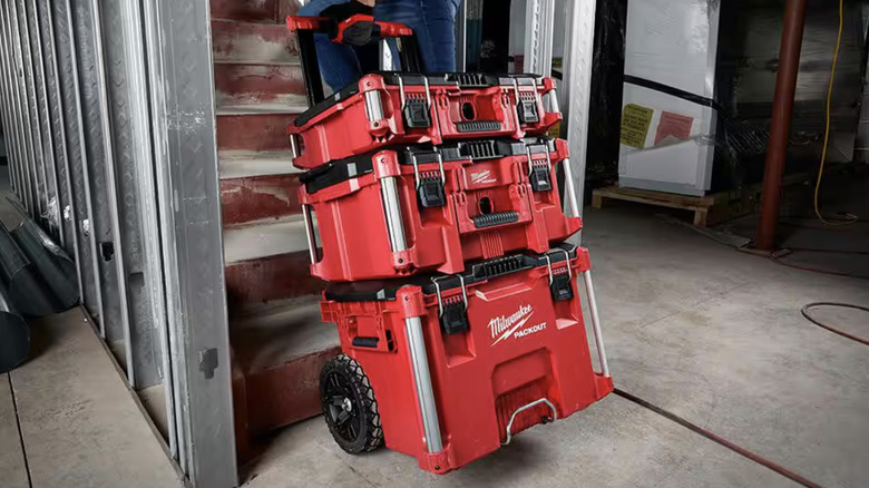 Person wheeling Milwaukee packout through a job site