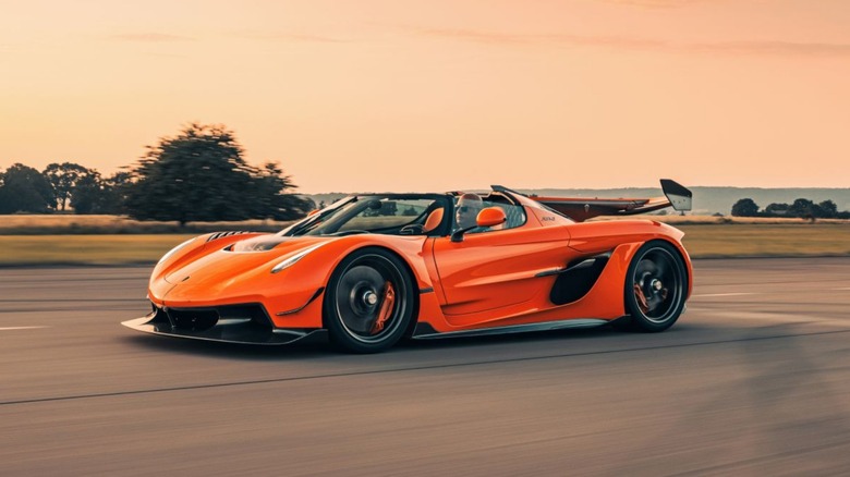 A person driving an orange koenigsegg jesko attack