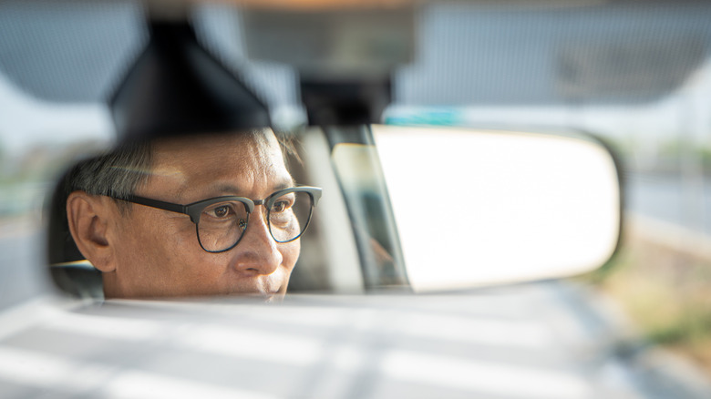 View of driver in rear view mirror