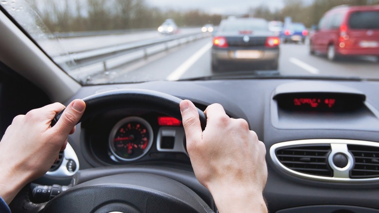 Close up shot of driver's hands on the wheel