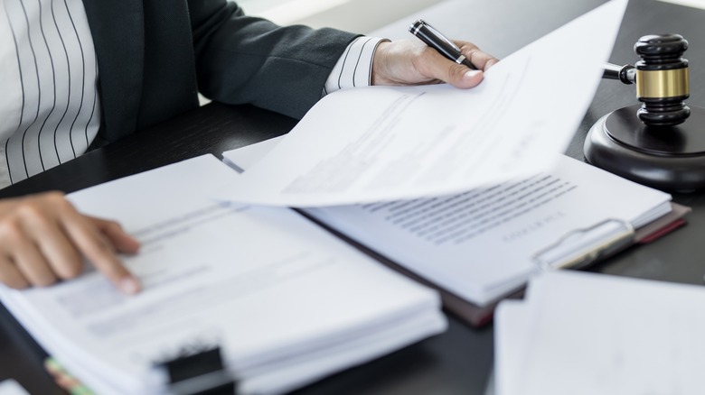 A close up shot a person reviewing legal documents