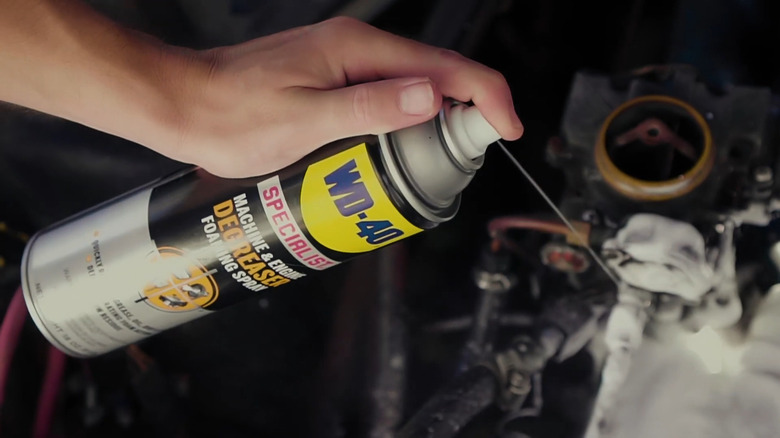 person using WD-40 Specialist Machine & Engine Degreaser