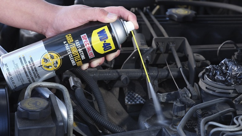 person using WD-40 Specialist Carb/Throttle Body Cleaner