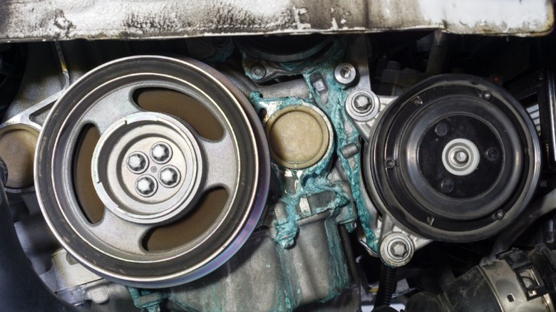 a closeup image of an engine with a coolant leak