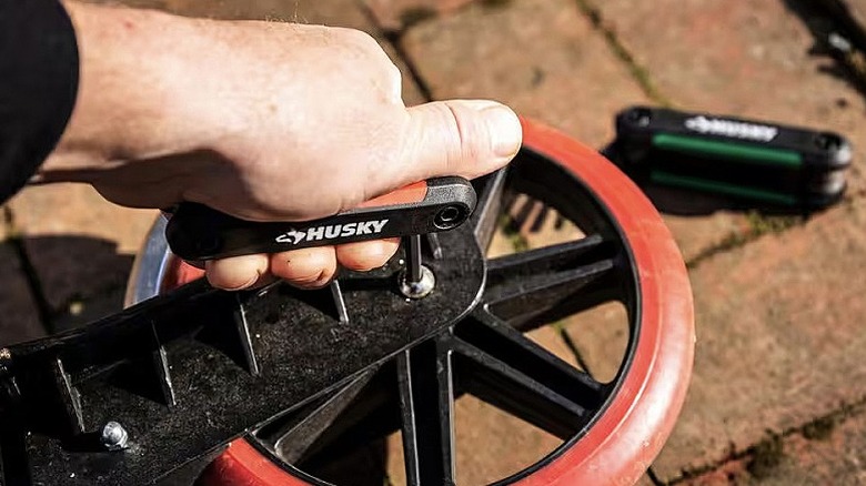 Man inserting Husky hex key into wheel bolt