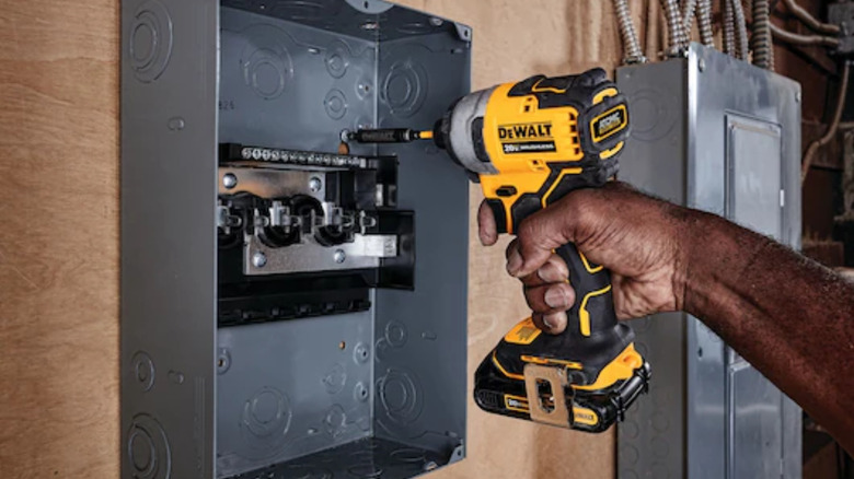 Person using a DeWalt impact driver to tighten a screw