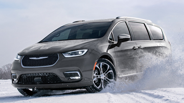 Front 3/4 view of 2025 Chrysler Pacifica sliding through snow