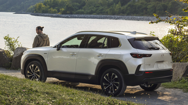 white 2025 Mazda CX-50 parked by lakeside