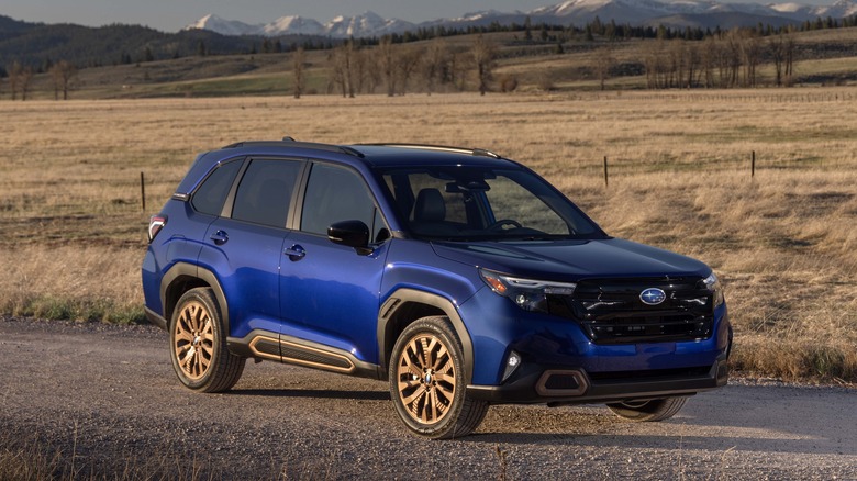 blue 2025 Subaru Forester on rural road