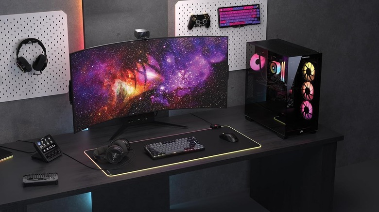 A desk with a gaming PC and monitor on it.