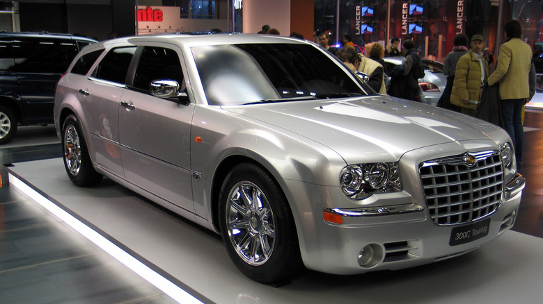 The Chyrsler 300C Touring in silver at an auto show, front 3/4 view