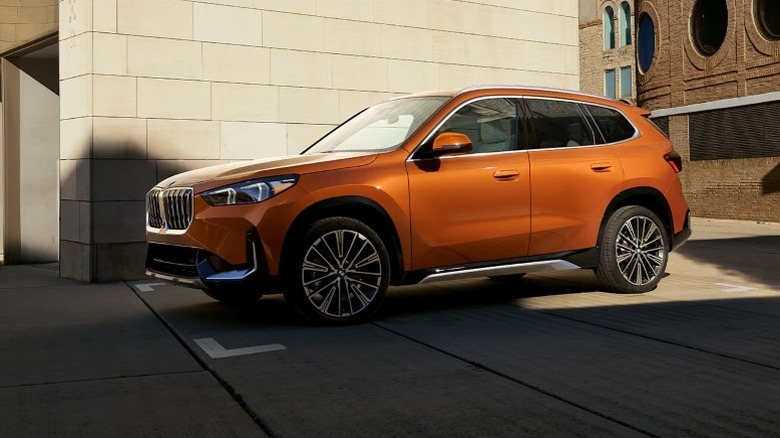 2025 BMW X1 parked on concrete pavement next to a building