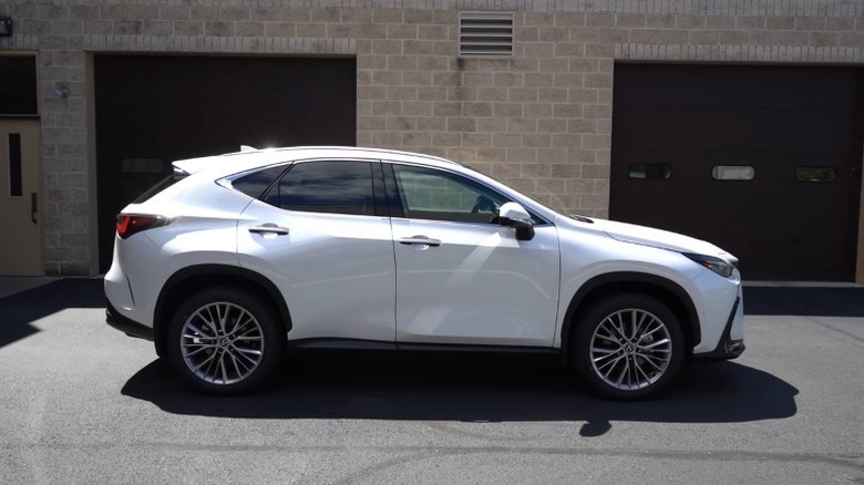 Eminent white 2025 Lexus 350 AWD parked in front of a building