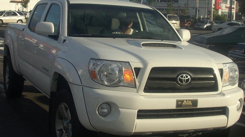 White Toyota Tacoma pickup parked in lot