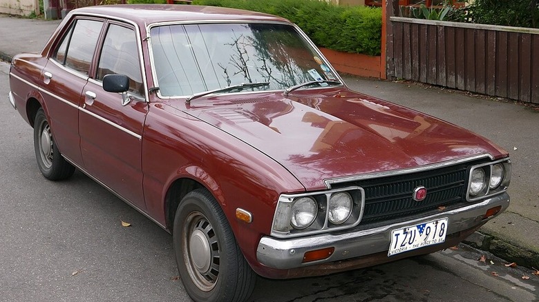 Red 1975 Toyota Corona parked on roadside