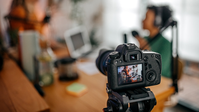 Digital camera recording two people doing an interview