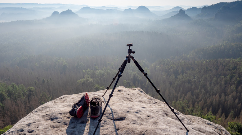 camera tripod with tripod head and mountain landscape