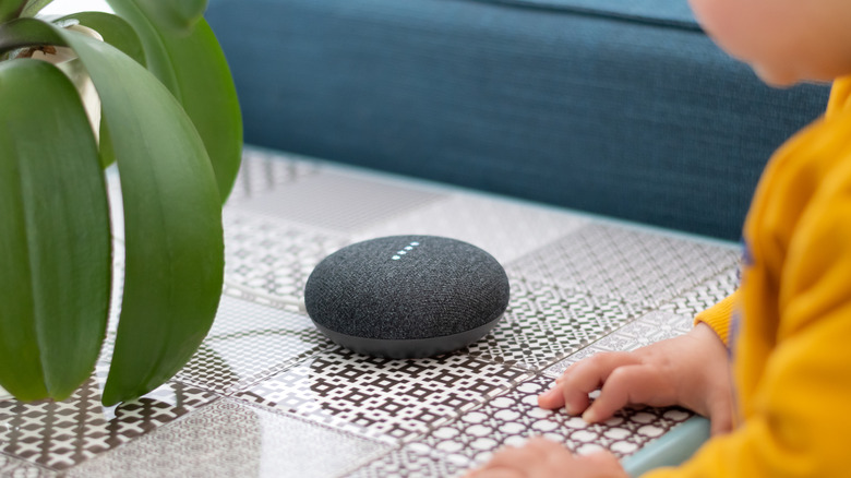 Google Home Mini on table with child